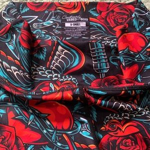 Constantly Varied Gear black shorts with red roses & teal swallows